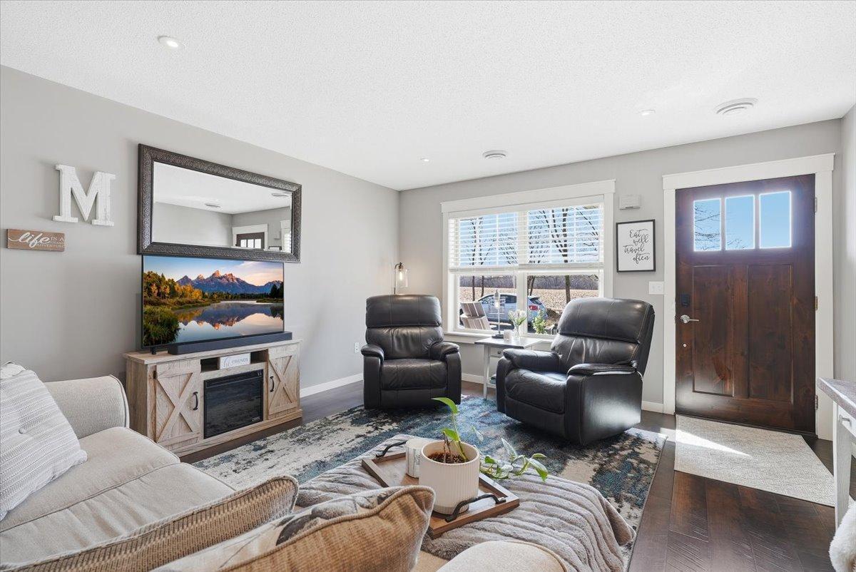 Bright open floorplan with recessed lighting and wooden blinds