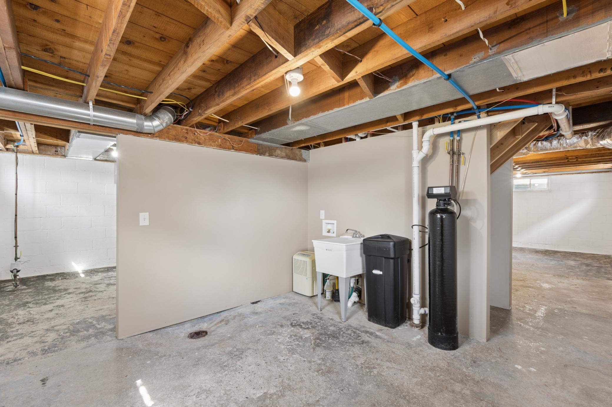 The water softener (2015) is included. Additional laundry hookups can be found in the basement.