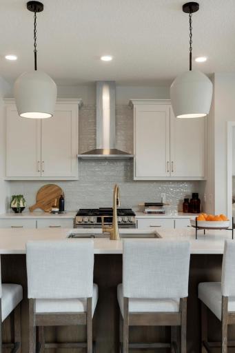 White cabinets with stunning gold accents.