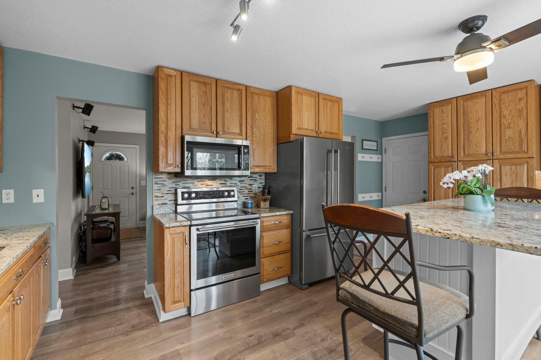 Beautiful LVP floor spans the main level kitchen, living room and hallway.