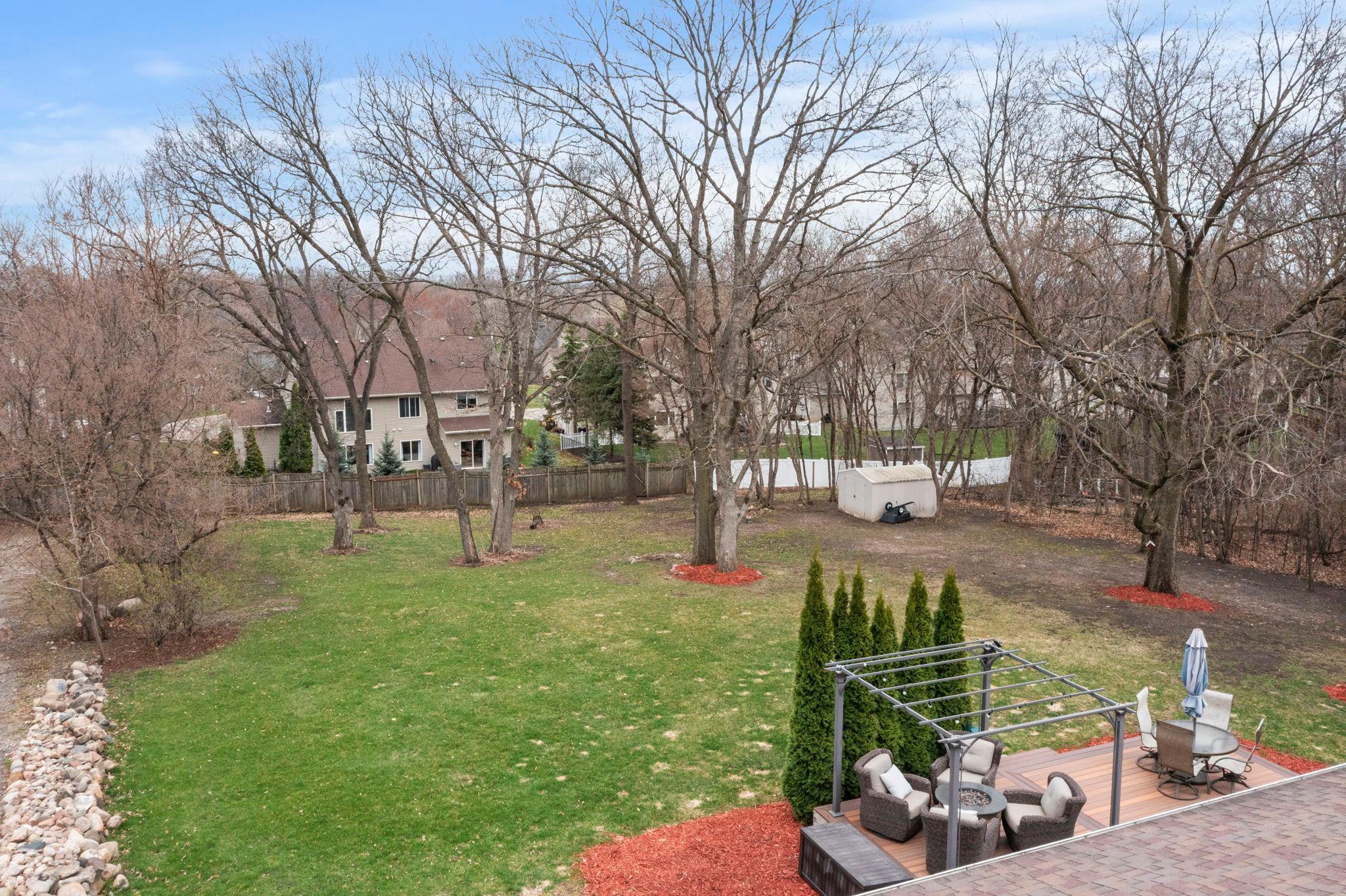 What a backyard just ready for someone new to enjoy! Lots of room to run and play! Beautiful mature trees almost ready to bloom.