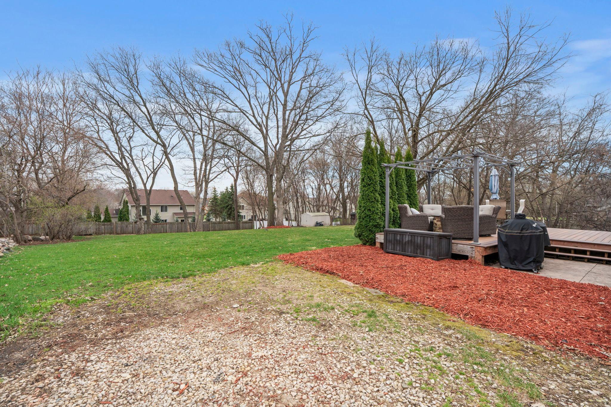 What a backyard just ready for someone new to enjoy! Lots of room to run and play! Beautiful mature trees almost ready to bloom.