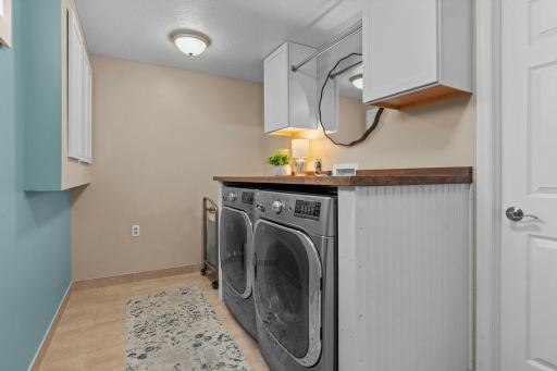 Fully finished laundry room. Newer washer and dryer.