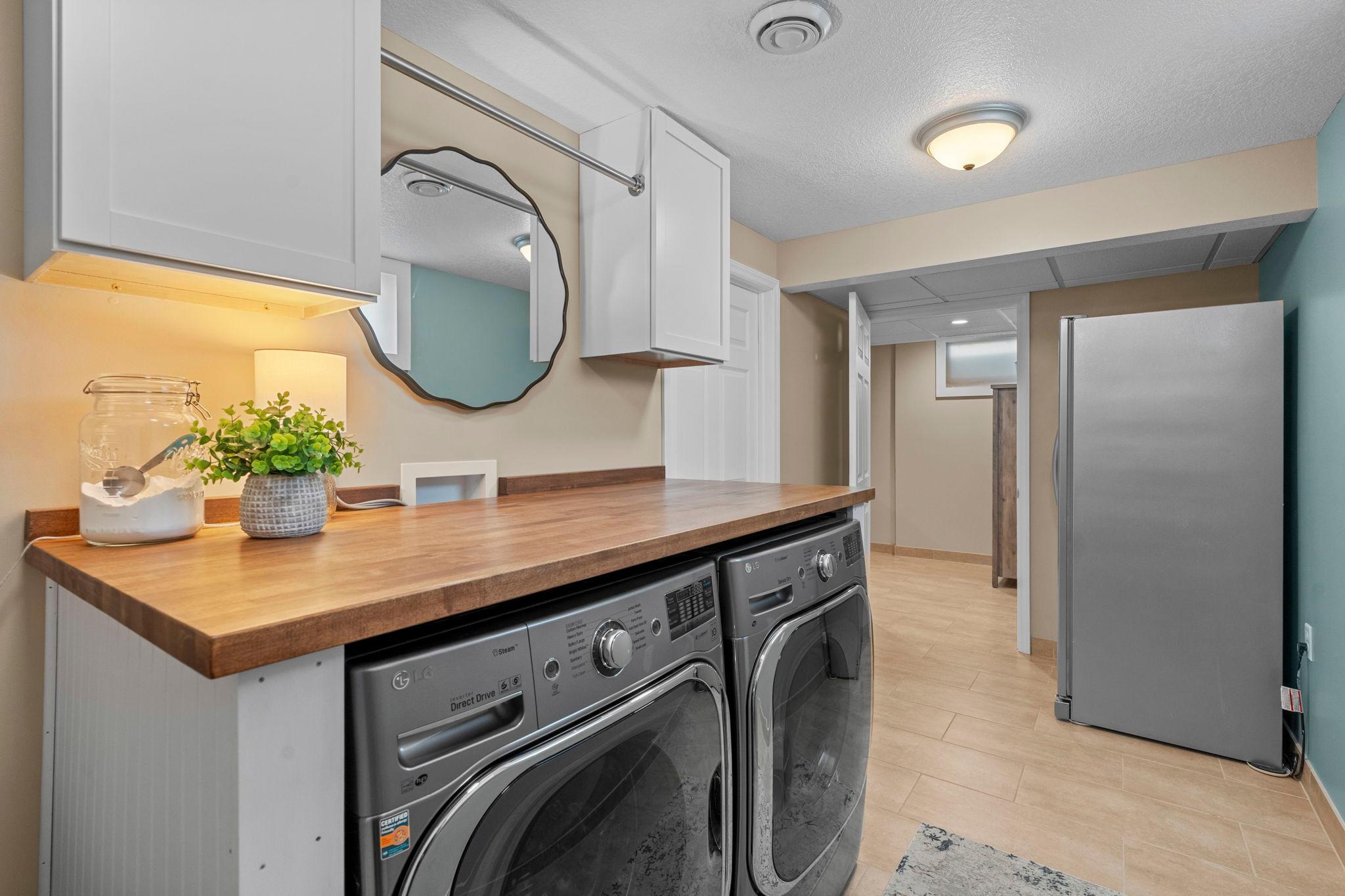 Fully finished laundry room. Newer washer and dryer.