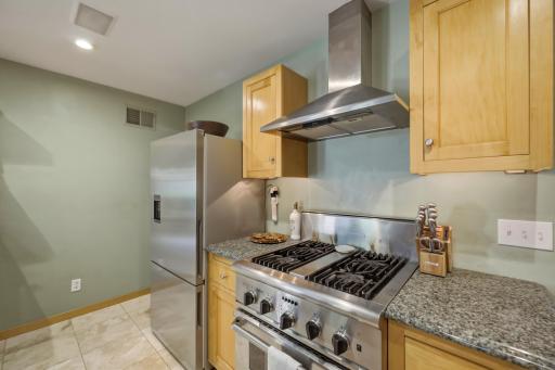 Professional-grade stainless steel appliances, a pro-style gas range, and a stainless hood â this kitchen is ready for the serious home cook.