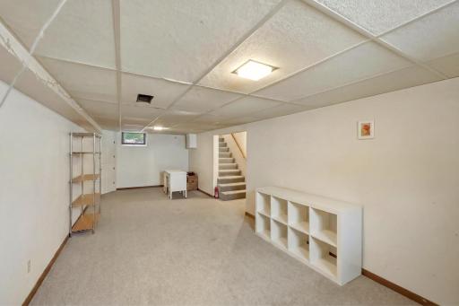 A spacious finished lower level with a separate laundry and storage room (not visible). Digitally edited to remove storage boxes to show the possibilities â plenty of room for a family room, play space, gym, or home office.