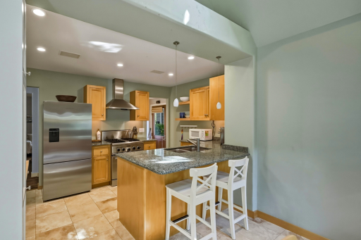 Breakfast bar, gas range, newer stainless refrigerator and dishwasher, recessed lighting â everything you need.