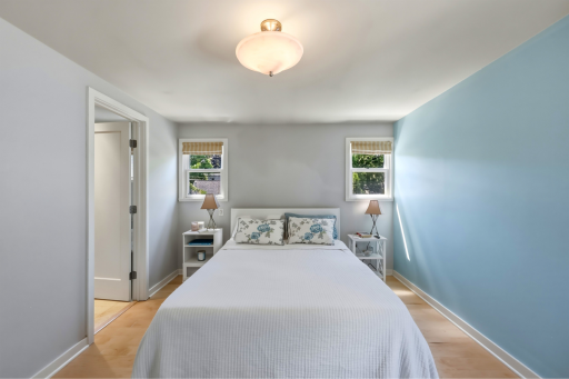 Another view of the primary bedroom â notice the size, the light, and the easy flow to the en suite bath.