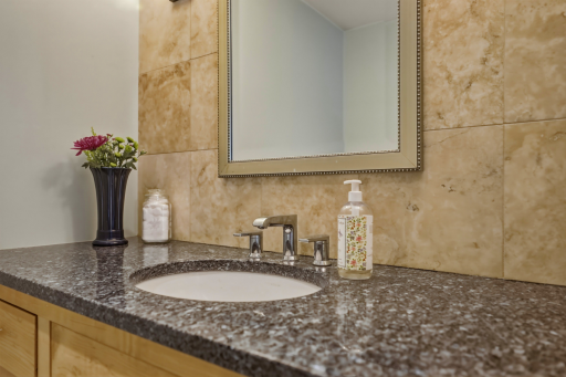 Granite countertop, undermount sink, abundant storage, and luxe tile surround â the details that make mornings feel easy.