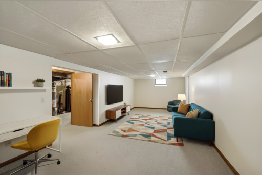 Finished basement - AI staged to show the possibilities! Big enough for a TV room, home office, workout area, or playzone!