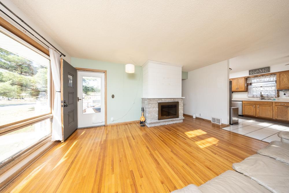 When you walk into the living room, you can't help but notice the beautiful stone fireplace that anchors the room