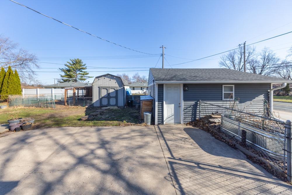 Large patio, accessible just off the kitchen, insulated garage, and one of two sheds on the property