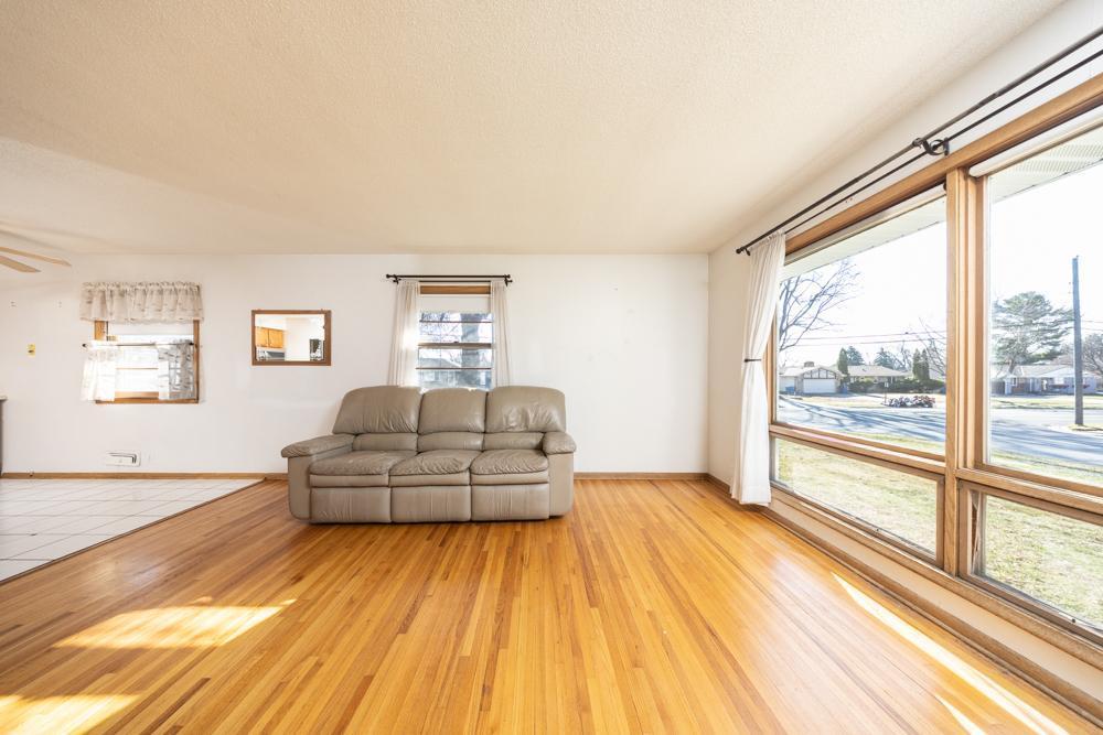 The bright living room is filled with natural light from the large windows