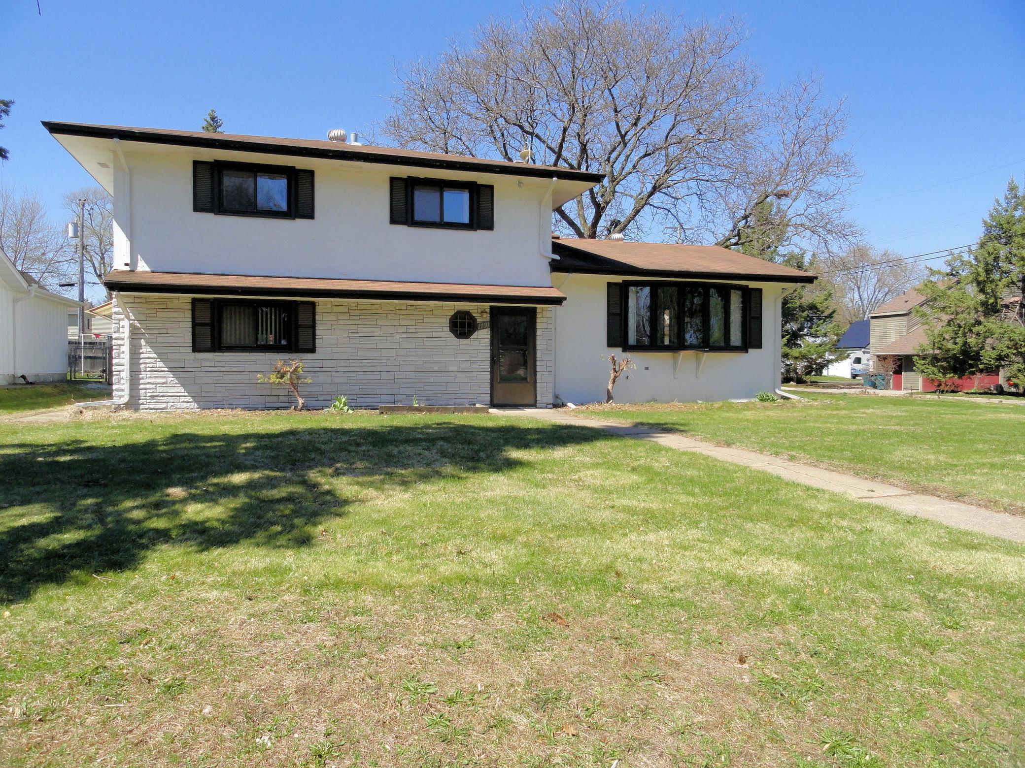 Another view of front of this home & the shadow cast from one of the evergreens at home here.