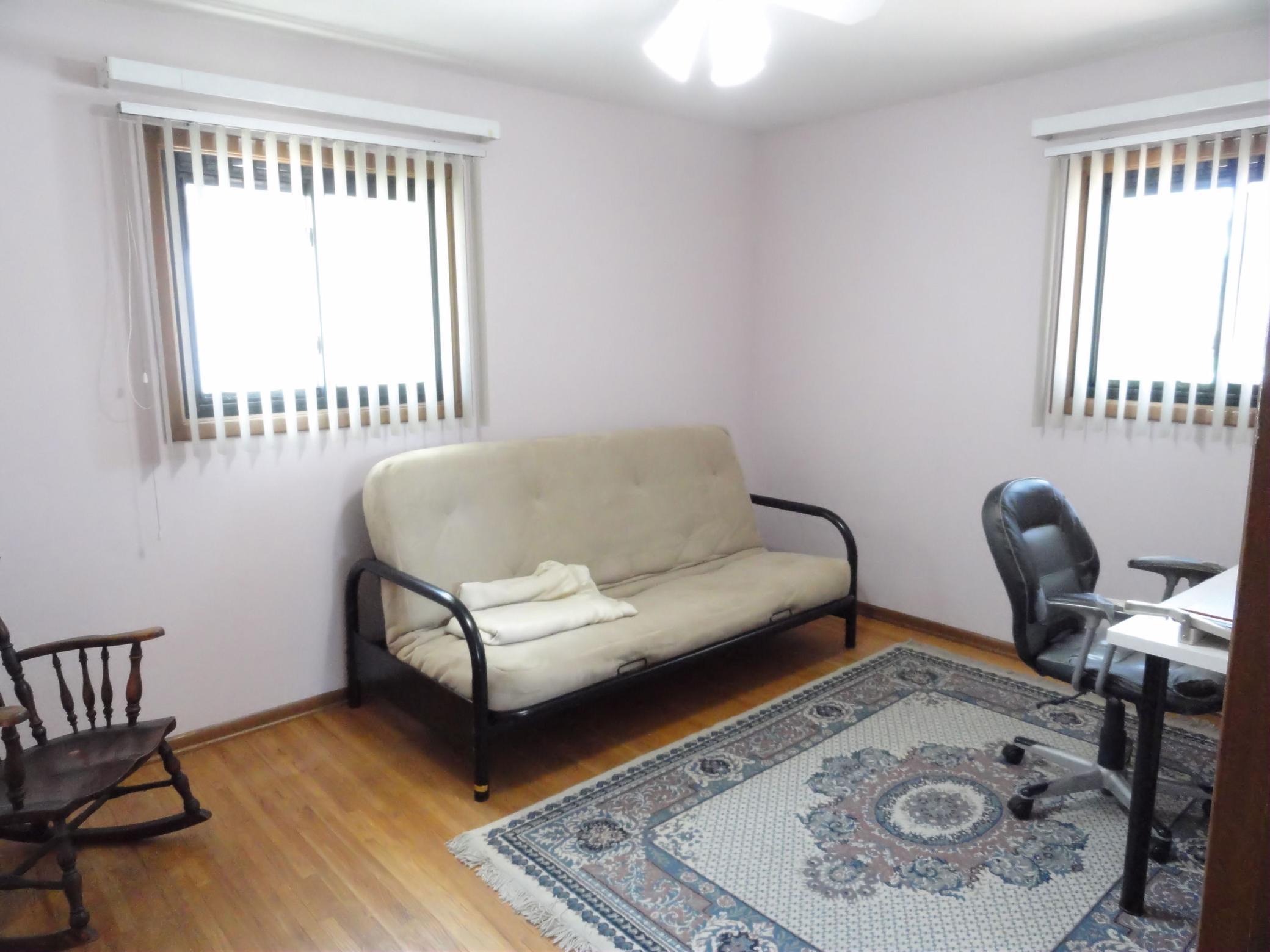 Another upstairs bedroom, currently seen as a flex space with a day bed. Real hardwood floors, a ceiling fan & windows for air flow. Maybe the bonus room becomes your flex space or office or imagination space.
