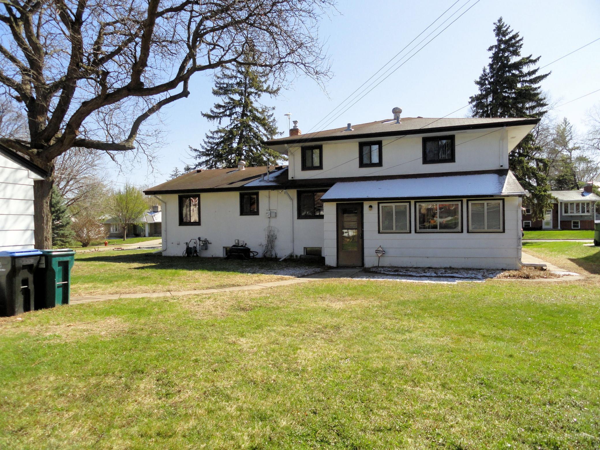 From the level backyard, here is a view of the 3 season porch on the back of this home.