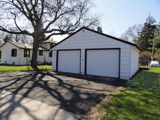 Better than other 2 car garages! The twin overhead doors provide more space between your vehicles! Easier snow removal than long driveways elsewhere. Easier coming & going because there's no alley. Ideal for parking 4 cars, 2 inside & 2 outside!