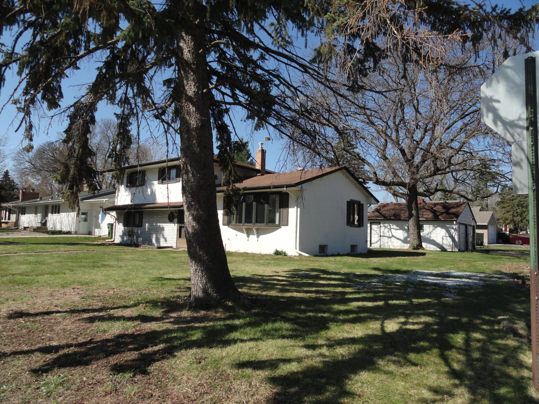 A pair of evergreen trees add constant color to this front yard & attract nesting song birds too.