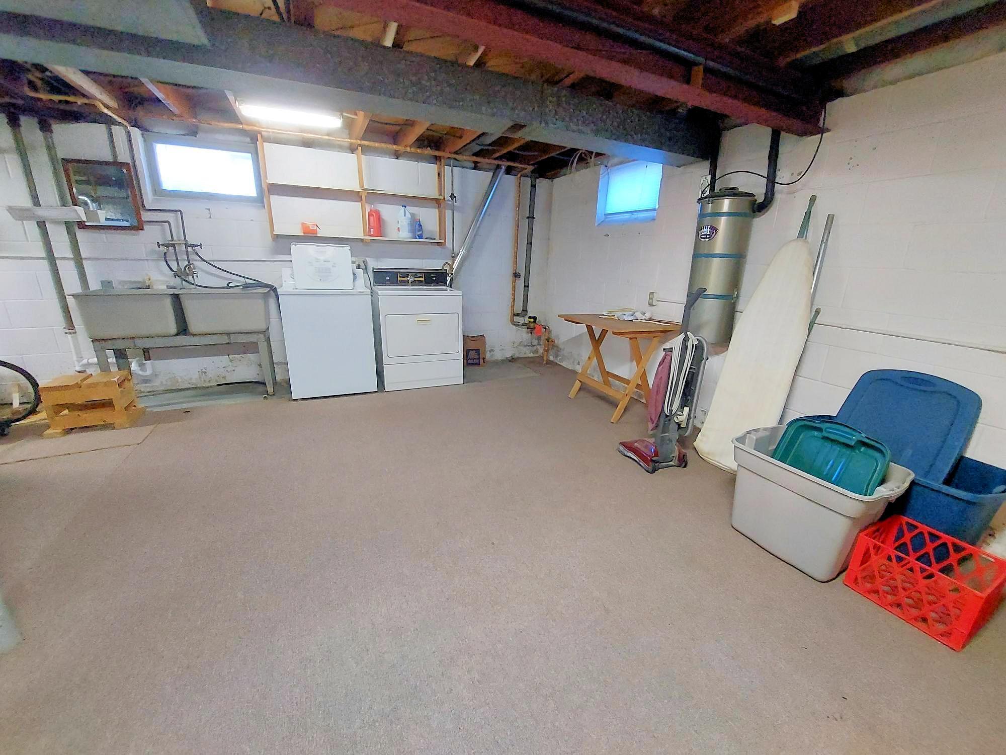 At home laundry in the unfinished basement. A large twin basin laundry sink adds extra options for you. Out of camera view, a hobby bench & bonus storage closets are also here.