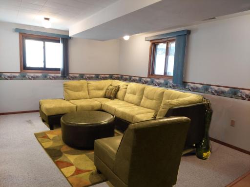 This ground level entertainment room gives you a 3rd indoor space to gather with family & friends. In this image is just one way that you might furnish this splendid space. virtual staged