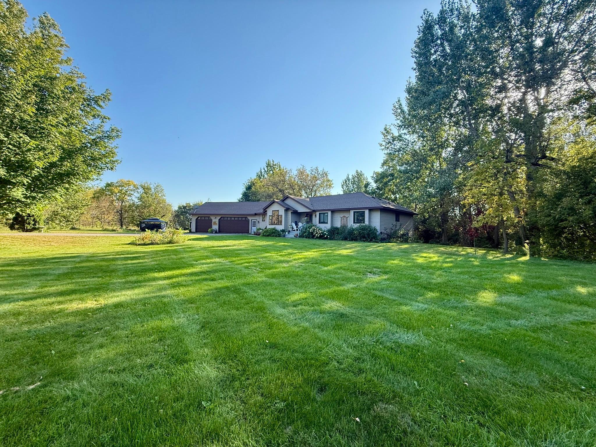 Large front yard with privacy tree line