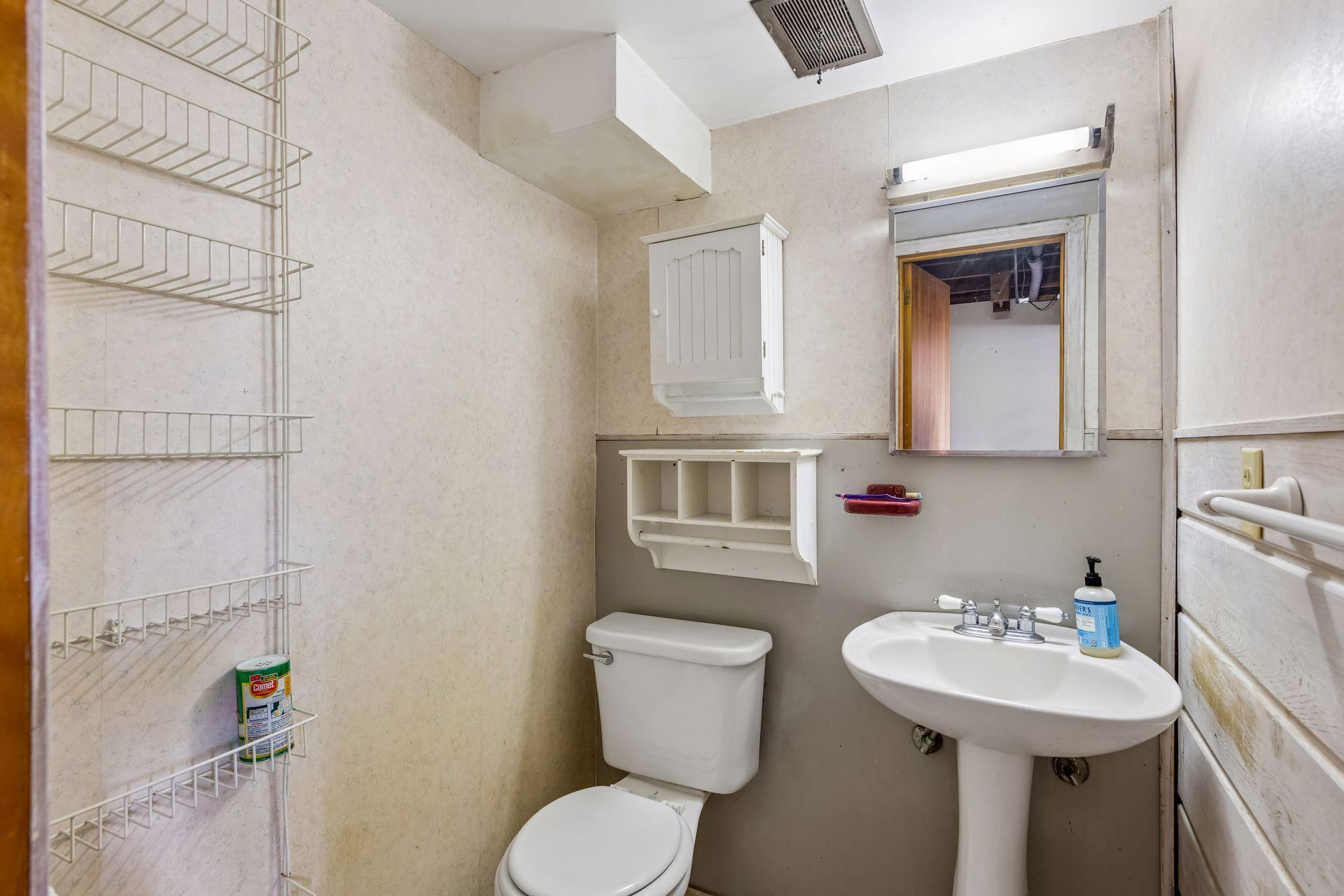 The lower level half bath has a pedestal sink