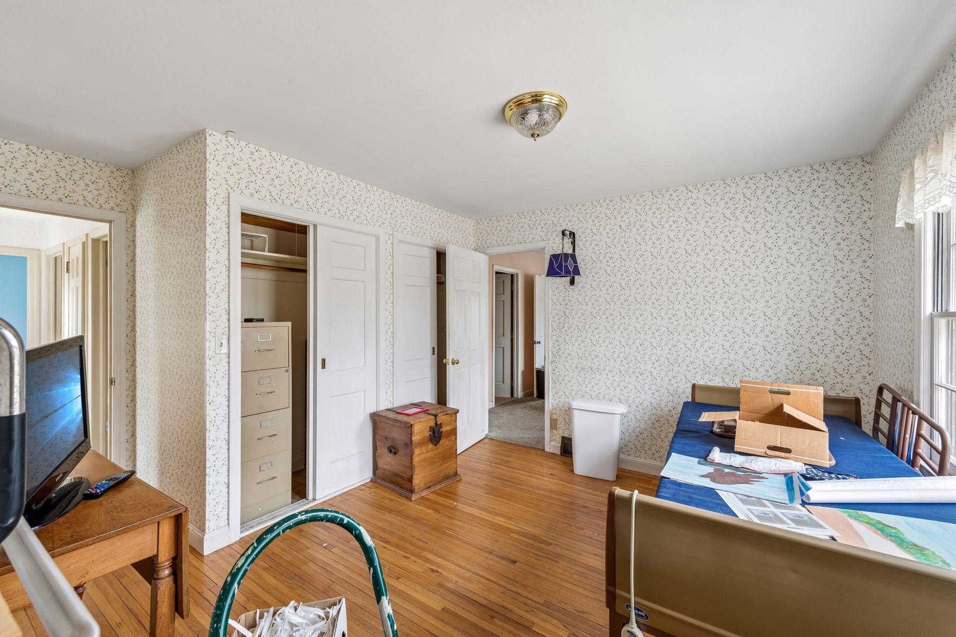 The main level den/office leads into the primary bedroom