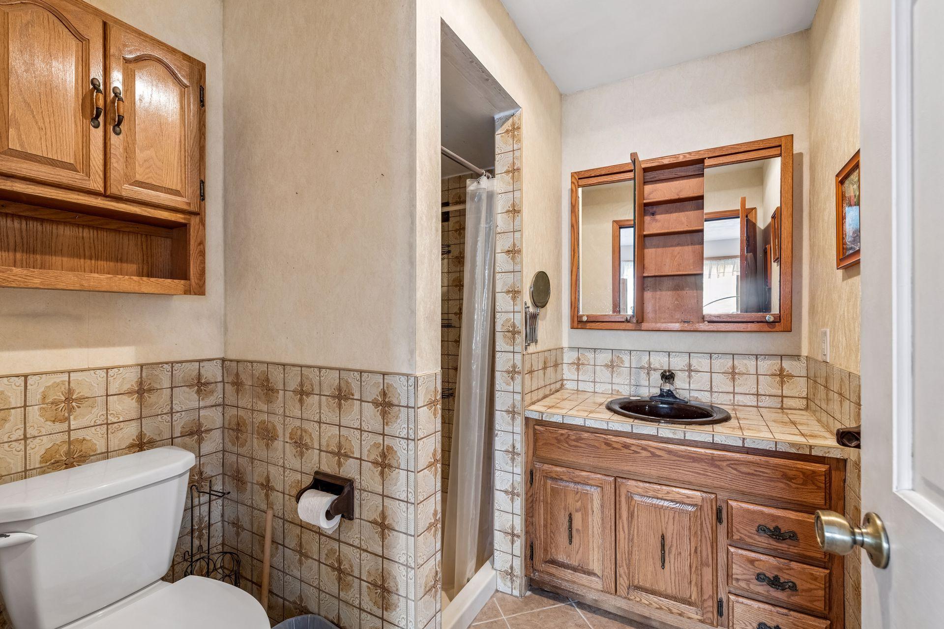 The tiled primary bath has a walk in shower