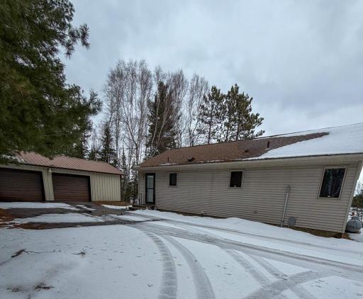 Exterior of home and detached oversized 2-car garage. New siding on house will be installed prior to closing.