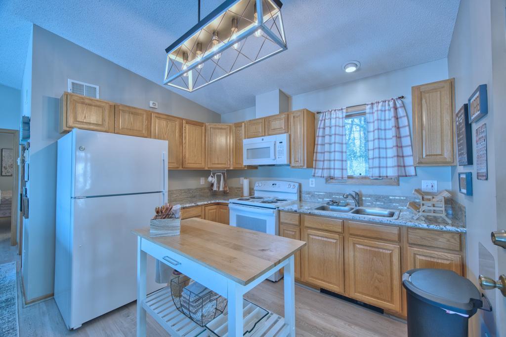Kitchen offers new sink, stove, microwave, countertop and backsplash (2024).