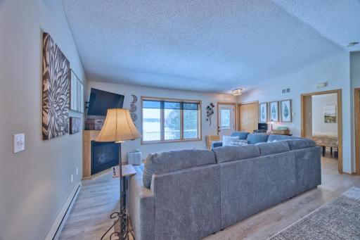Living room with gas fireplace and lake view. All furniture is new as of September 2024.