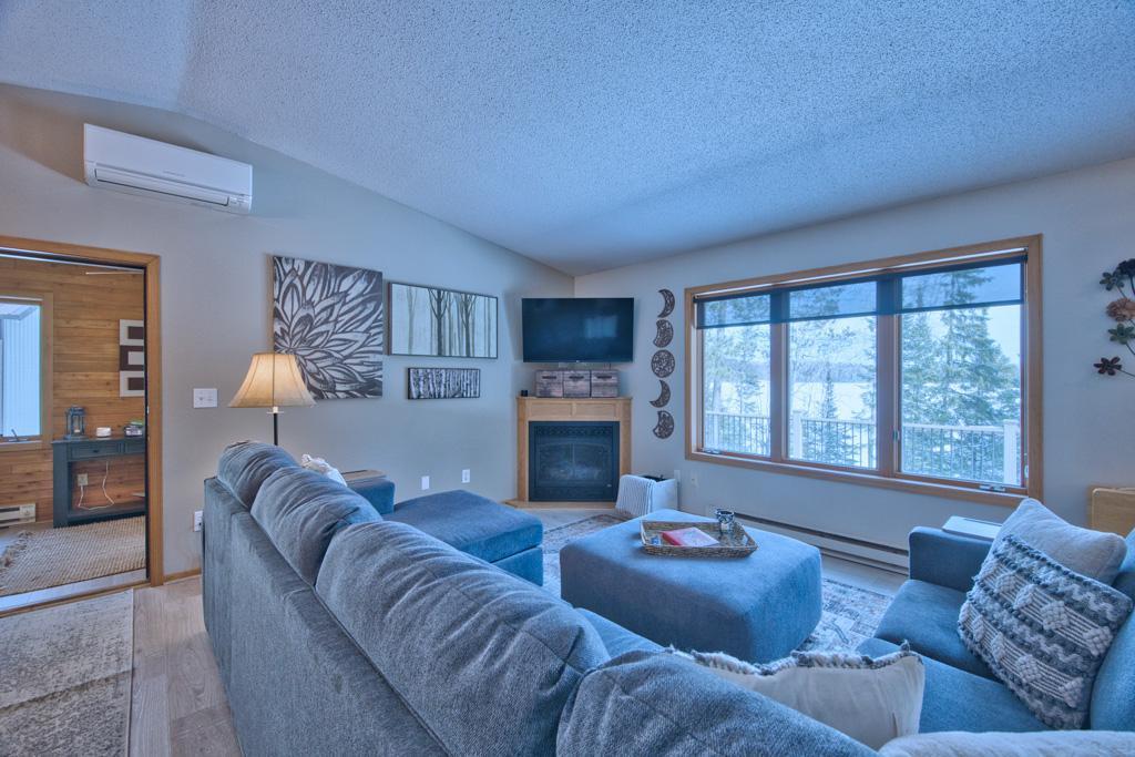 Living room with gas fireplace and lake view.