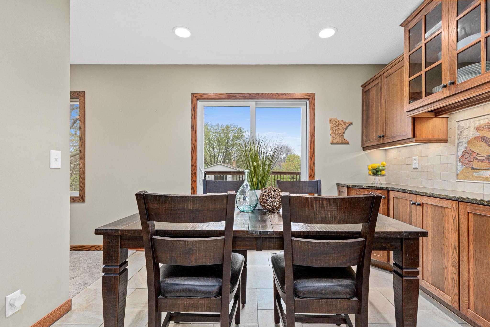 The walk out dining area with views to the deck invites connection over meals and conversation.