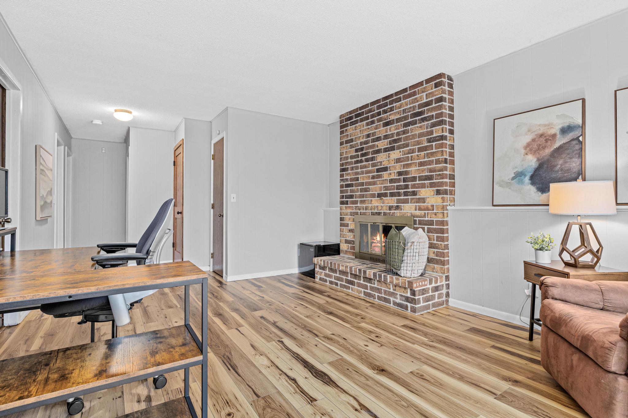 Spend cozy nights around the brick fireplace in the lower level family room