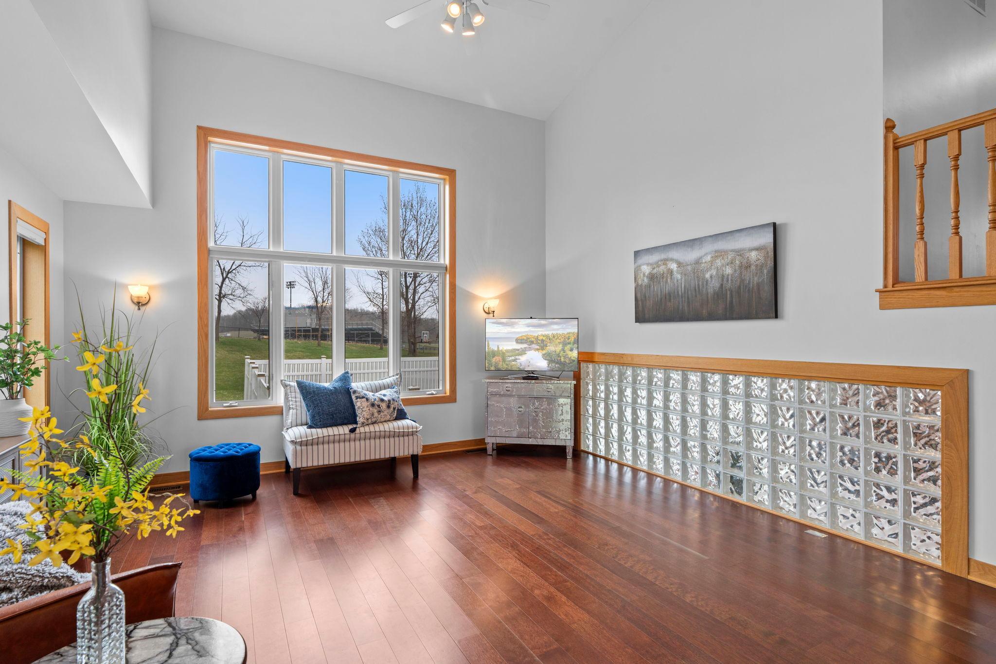 Gorgeous living room with vaulted ceilings, new ceiling fan and amazing views of your backyard oasis!