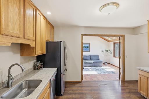 Kitchen flows right into a warm and inviting three season porch