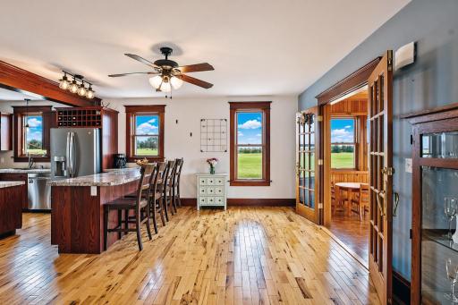 This inviting informal dining room features a convenient breakfast bar, perfect for casual morning meals, quick weeknight dinners, or entertaining guests in a relaxed and effortless setting.