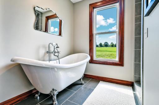 Stunning clawfoot soaking tub takes center stage, inviting you to unwind in style.