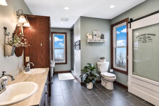 Natural light pours in making this spacious bathroom feel open and airy.