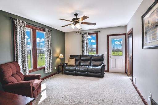 This comfortable and welcoming living room offers a warm, neutral canvas with ample space for seating and decor, creating the perfect gathering place to relax and unwind.