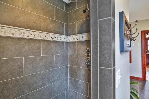 Fall in love with the walk-in shower with tile surround and rainfall shower head.