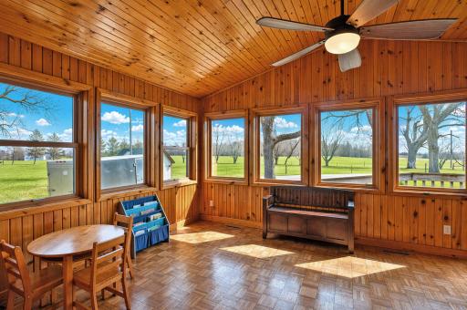 This sun-drenched sunroom, wrapped in windows and flooded with natural light year-round, creates the perfect space for a cozy reading nook, indoor garden, morning coffee retreat, or casual entertaining area.