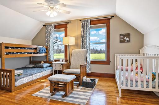 A well-proportioned bedroom with large windows that invite natural light, neutral wall tones, and offering a peaceful retreat with plenty of room to personalize.