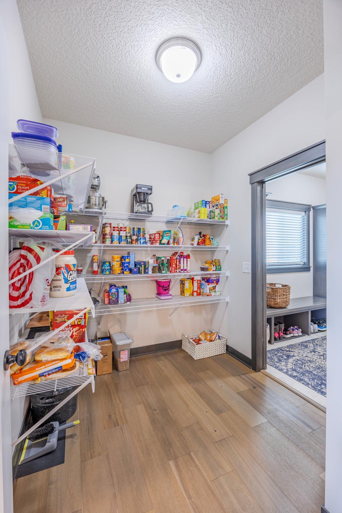 Putting away groceries has never been easier with this large pantry conveniently located off the kitchen and mudroom.