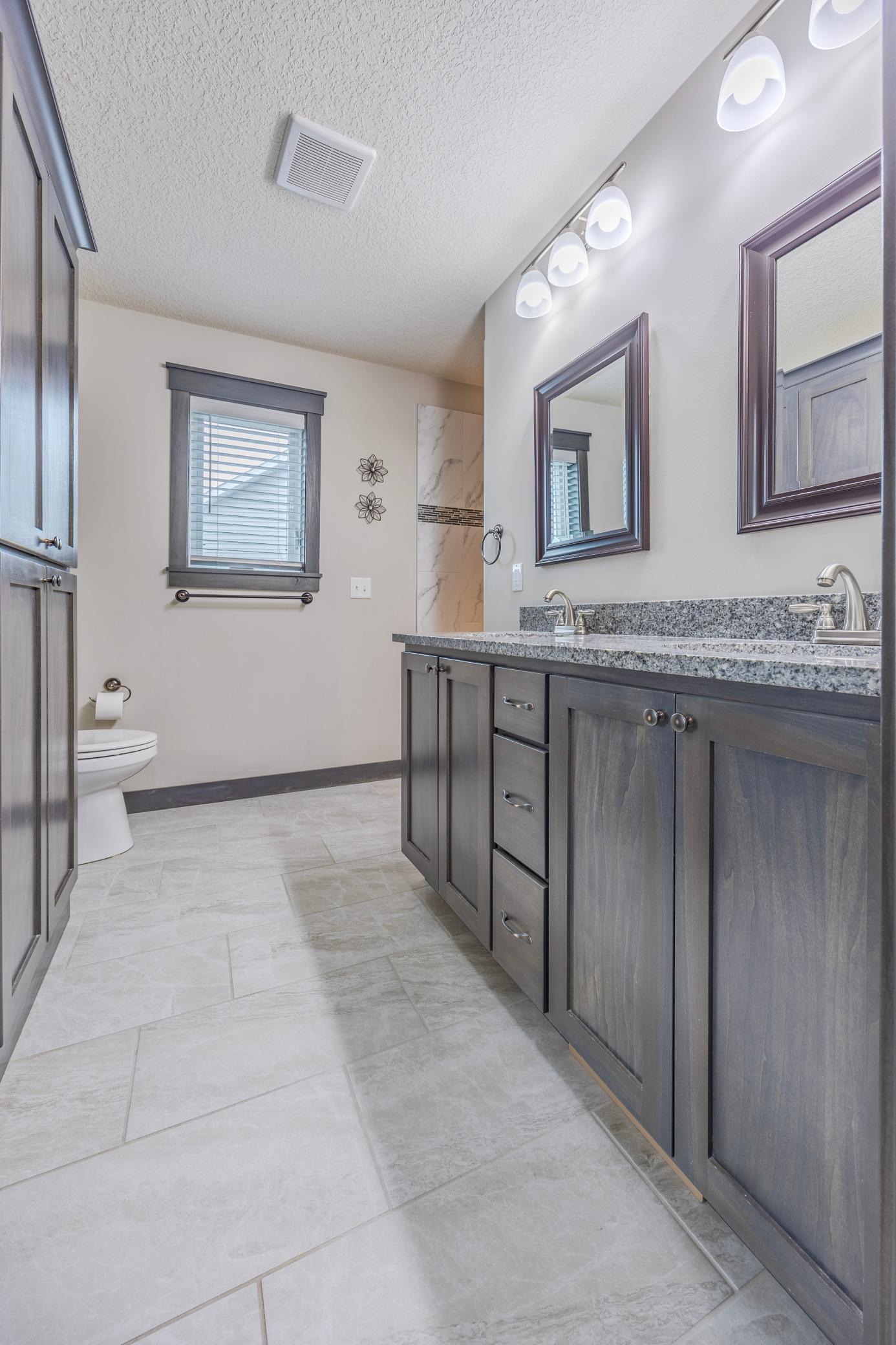 Luxurious ensuite bathroom attached to the main bedroom, with dual sinks.