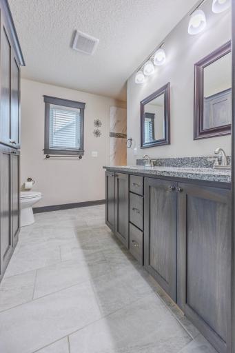 Luxurious ensuite bathroom attached to the main bedroom, with dual sinks.