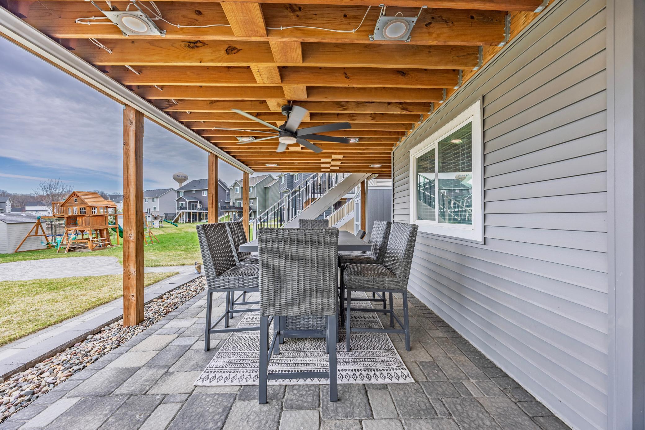 2 ceiling fans and can lights creates a beautiful outdoor space.