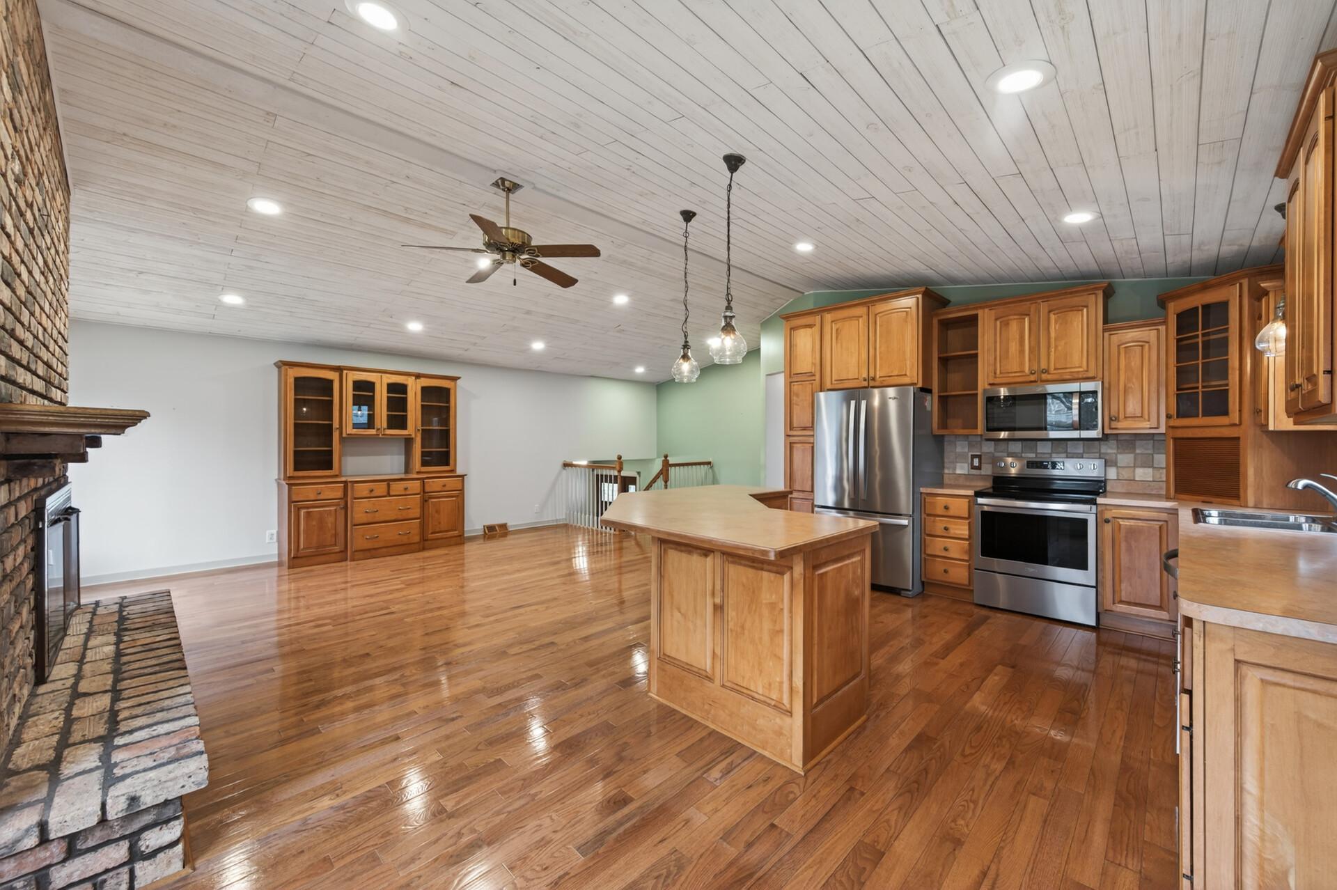 Here is an alternate view of the dining room, kitchen, and living room.
