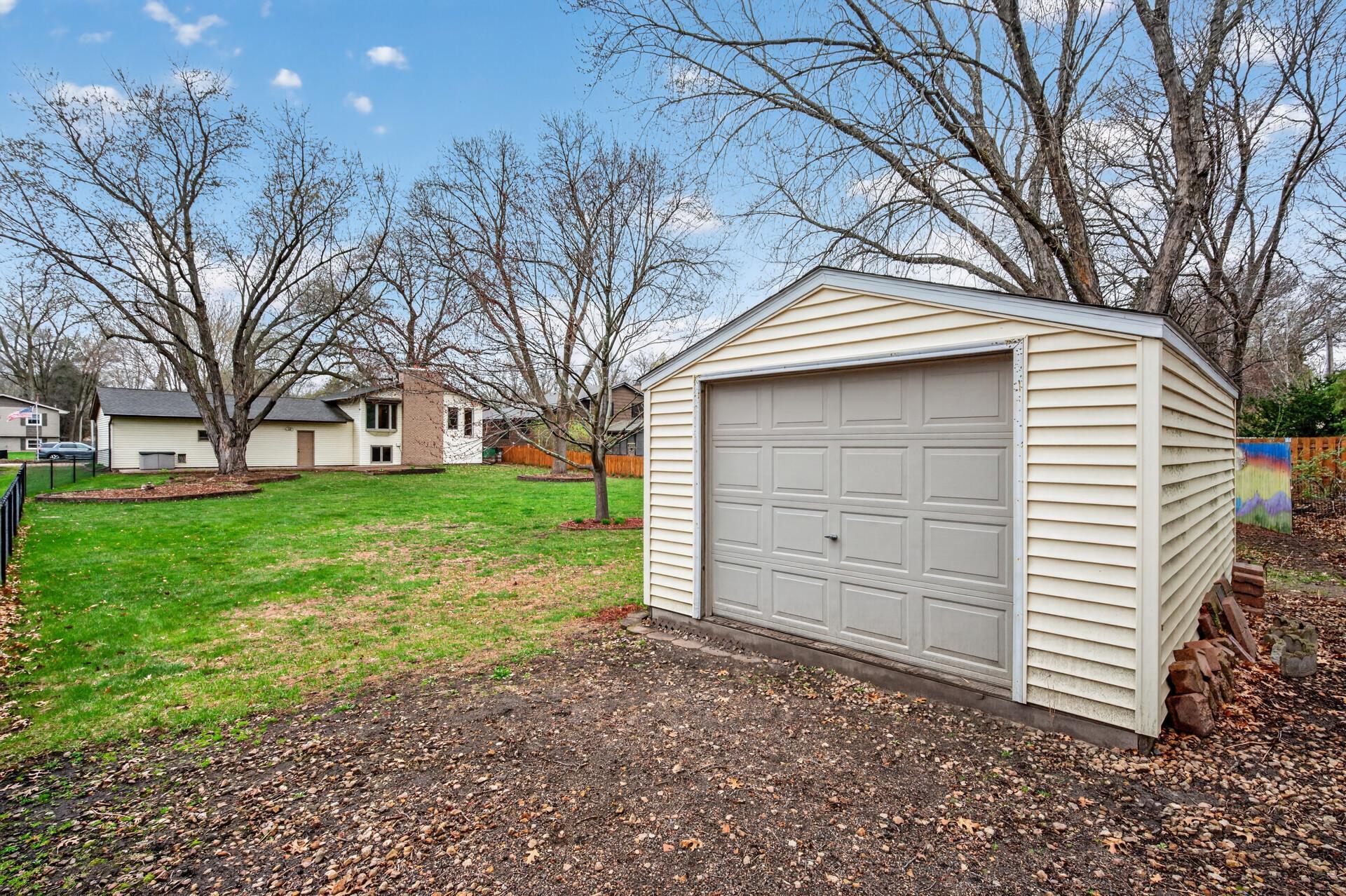 The large 12' x 16' shed with a garage door offers extra storage for tools, equipment, or hobbies.