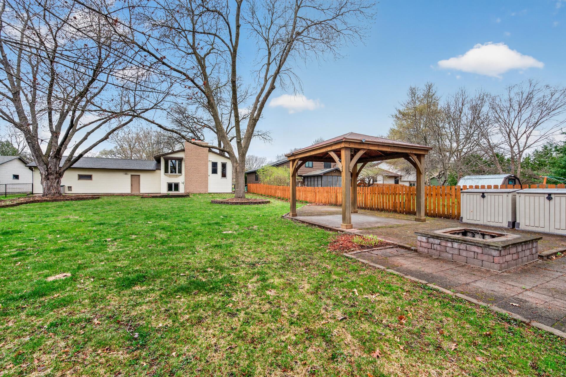A charming gazebo creates the perfect spot to relax or entertain, while the firepit invites cozy evenings under the stars.
